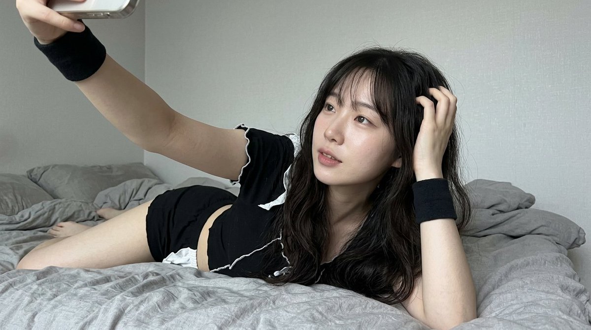 Intimate Smartphone Selfie of a Woman in Maid Outfit