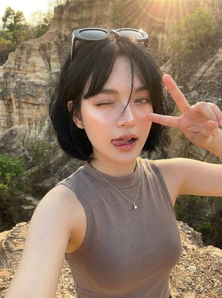 High-Angle, Top-Down Selfie Of A Young Woman With A Short