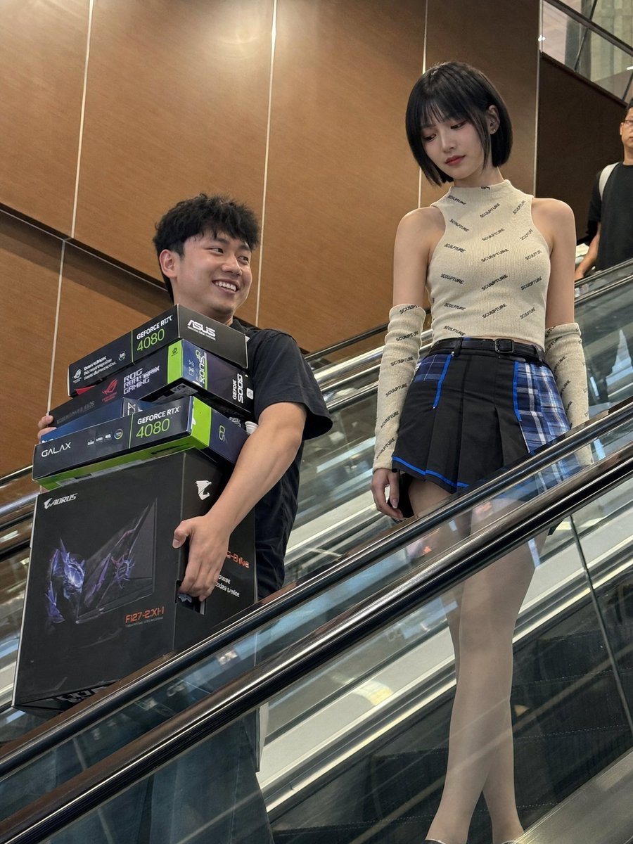 Candid Phone Photo of Tech Shoppers on Escalator