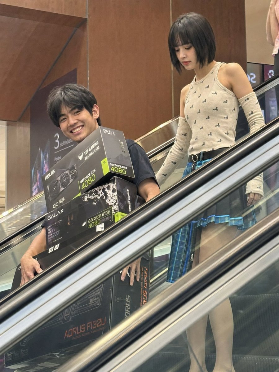 Candid Phone Photo of Tech Shoppers on Escalator